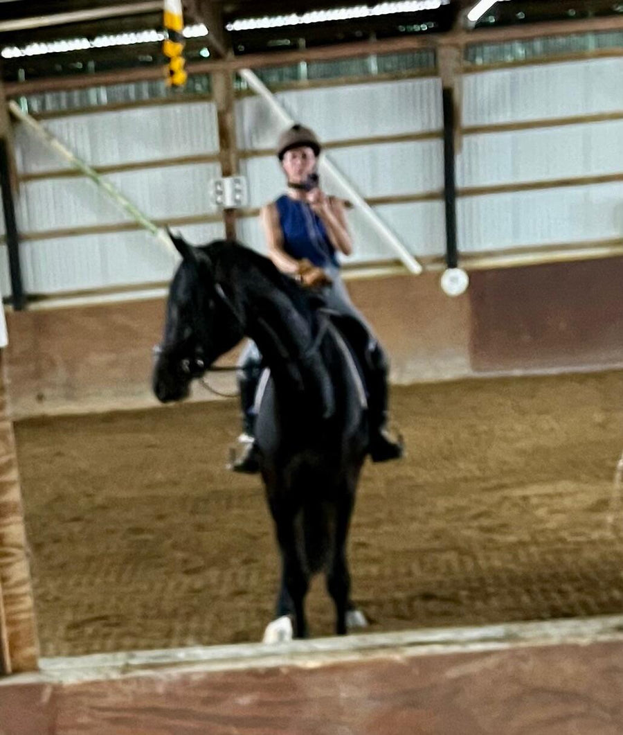 Customer Debb M. riding her black horse in a Cavalon Eggbutt Lozenge Leather Covered Snaffle