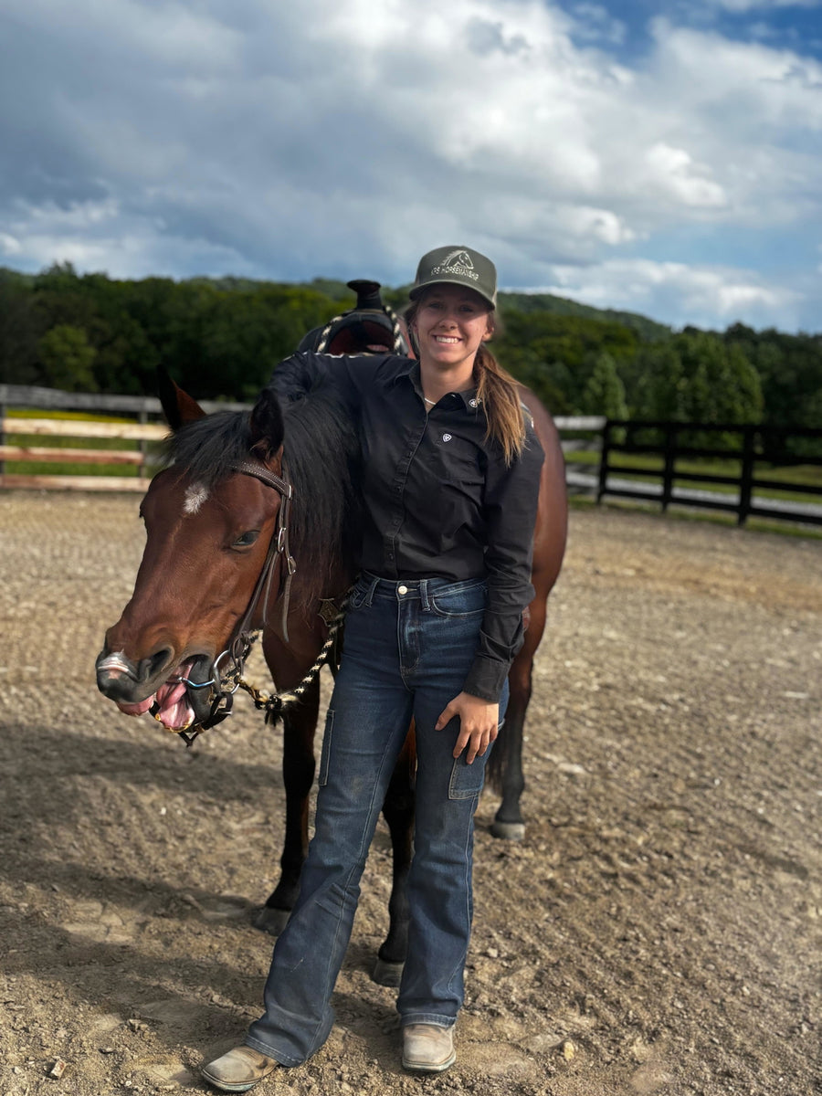 Customer Kayla R. standing with her bay horse wearing a Cavalon Eggbutt Capsule Sweet Iron Snaffle
