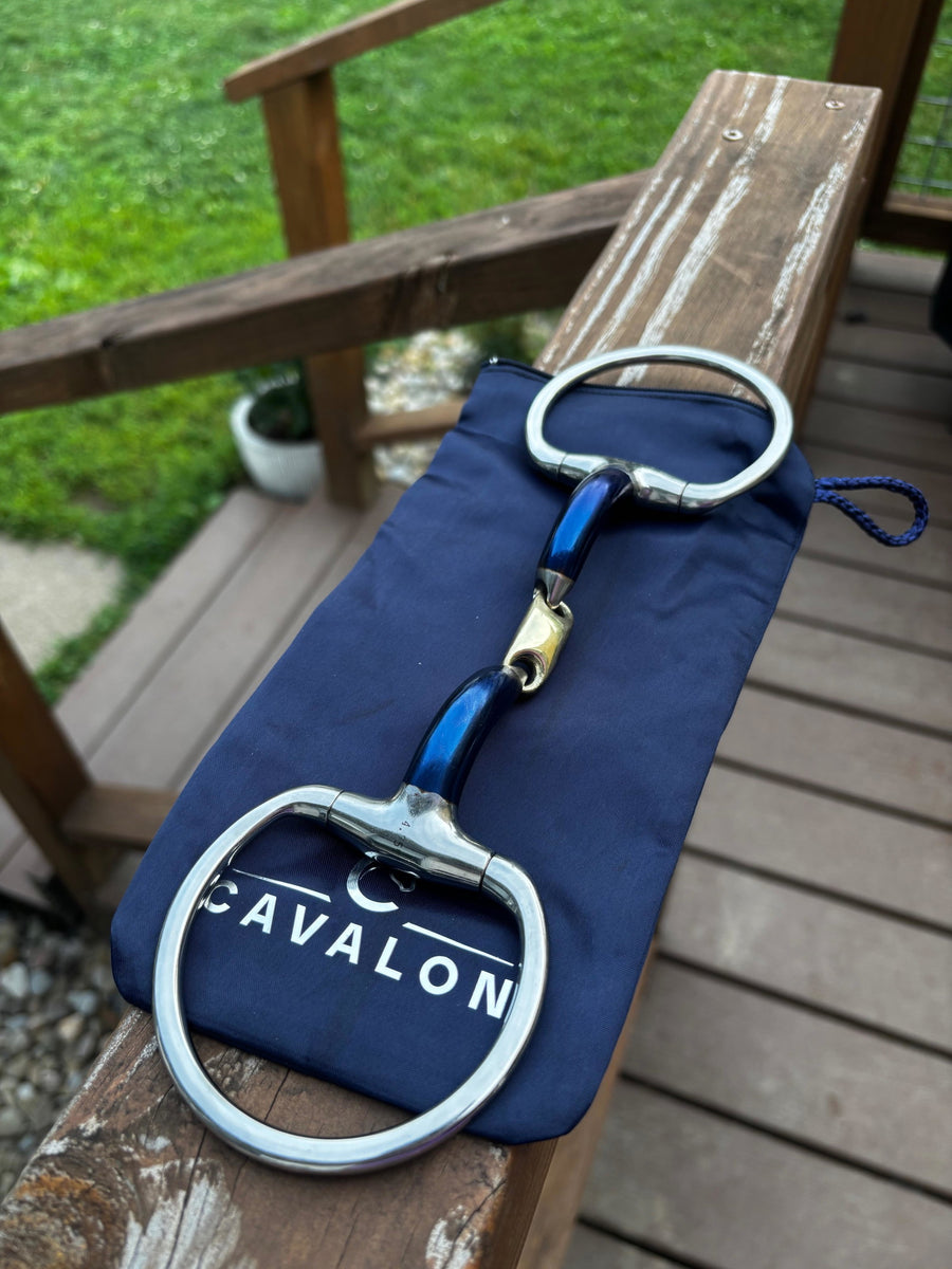 Cavalon Eggbutt Lozenge Sweet Iron Snaffle resting on a Cavalon branded bit bag